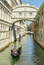 Gondola riding under Bridge of Sighs close to San Marco Square in Venice, Italy Royalty Free Stock Photo