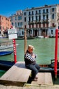 Venice, Italy - April 06, 2018: Gondolier expects tourists.