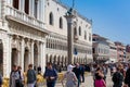 Restaurants and tourists at the famous Saint Mark Square of Venice in a beautiful sunny early spring Royalty Free Stock Photo