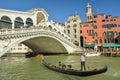Tourists riding on Gondola under the Rialto Bridge on Canal Grande in Venice, Italy Royalty Free Stock Photo