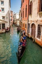 Tourists sailing in a gondola on the beautiful canals of Venice in an early spring day Royalty Free Stock Photo