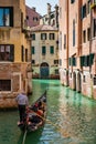 Tourists sailing in a gondola on the beautiful canals of Venice in an early spring day Royalty Free Stock Photo