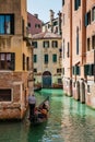 Tourists sailing in a gondola on the beautiful canals of Venice in an early spring day Royalty Free Stock Photo