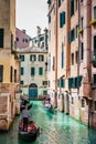 Tourists sailing in a gondola on the beautiful canals of Venice in an early spring day Royalty Free Stock Photo