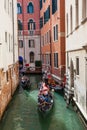 Tourists sailing in a gondola on the beautiful canals of Venice in an early spring day Royalty Free Stock Photo