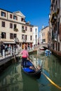 Tourists sailing in a gondola on the beautiful canals of Venice in an early spring day Royalty Free Stock Photo