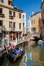 Tourists sailing in a gondola on the beautiful canals of Venice in an early spring day Royalty Free Stock Photo