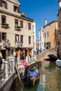 Tourists sailing in a gondola on the beautiful canals of Venice in an early spring day Royalty Free Stock Photo