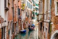 Tourists sailing in a gondola on the beautiful canals of Venice in an early spring day Royalty Free Stock Photo