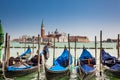 Traditional Venetian gondolas at the Grand Canal in front of the beautiful Basilica Di San Giorgio