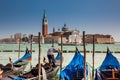 Traditional Venetian gondolas at the Grand Canal in front of the beautiful Basilica Di San Giorgio