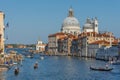 Venice, Italy - April 20, 2019: Traffic rush on Grand Canal with boats, gondolas and Venetian vaporetto. Basilica Santa Maria