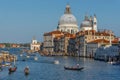 Venice, Italy - April 20, 2019: Traffic rush on Grand Canal with boats, gondolas and Venetian vaporetto. Basilica Santa Maria