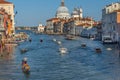 Venice, Italy - April 20, 2019: Traffic rush on Grand Canal with boats, gondolas and Venetian vaporetto. Basilica Santa Maria