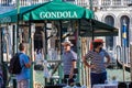 VENICE, ITALY - August 28, 2021: Gondoliers negotiating with a tourist in the canals of Venice in Italy