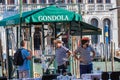 VENICE, ITALY - August 28, 2021: Gondoliers negotiating with a tourist in the canals of Venice in Italy