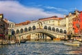 Venice, Italy - August 22, 2018: The Rialto bridge, a vaporetto, a ferry berth and gondolas in Grand Canal