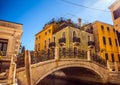 VENICE, ITALY - AUGUST 21, 2016: View on the cityscape and lovely bridge on the canal of Venice on August 21, 2016 in Venice Royalty Free Stock Photo