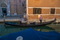 VENICE, ITALY - August 27, 2021: View of couple tourists entering gondola on canals of Venice Royalty Free Stock Photo