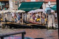 VENICE, ITALY - August 28, 2021: View of Gondoliers waiting for tourists, crowd of tourists in the background on the canals of