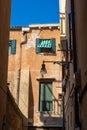 VENICE, ITALY - August 27, 2021:  View of windows and doors of houses on the streets of Venice Royalty Free Stock Photo