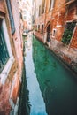 Venice, Italy. Beautiful view of the old style canals in Venezia. Reflection in water with small local boats Royalty Free Stock Photo