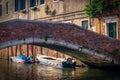 Venice, Italy. Boats and low bridge on a channel