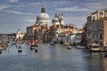 Venice, Italy: Boats sailing in the Grand canal and Basilica Santa Maria della salute against dramatic clouds Royalty Free Stock Photo