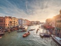 Venice, Italy - 17.10.2023: Busy water traffic with boats, taxi and gondolas in Rialto bridge area of the Grand channel. Warm