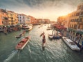 Venice, Italy - 17.10.2023: Busy water traffic with boats, taxi and gondolas in Rialto bridge area of the Grand channel. Warm