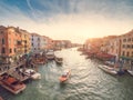 Venice, Italy - 17.10.2023: Busy water traffic with boats, taxi and gondolas in Rialto bridge area of the Grand channel. Warm