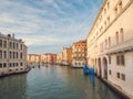 Venice, Italy - 17.10.2023: Busy water traffic with boats, taxi and gondolas in Rialto bridge area of the Grand channel. Warm