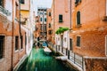 Venice Italy. Canal with old typical orange facade houses, patio and windows Royalty Free Stock Photo