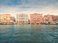 Venice, Italy - 17.10.2023: Colorful buildings by the Grand channel in Rialto bridge area with shops and restaurants. Warm sunny