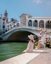 Venice Italy couple men and woman on a city trip at Venice,Rialto bridge in Venice Italy