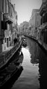 Venice, Italy, December 28, 2018 narrow passage through the calle of Venice with a gondola passing in the background
