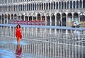 VENICE,ITALY dEmpty St Mark`s Square during a flood with beautiful water reflections of historical buildings on wet f Royalty Free Stock Photo