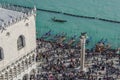 Venice, Italy elevated view of crowd during carnival at Gondola Ferry Pier in Saint Mark square, seen from San Royalty Free Stock Photo