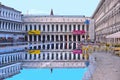 VENICE,ITALY Empty St Mark`s Square during a flood with beautiful water reflections of historical buildings on wet f Royalty Free Stock Photo