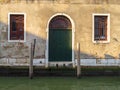 Venice, Italy. Entrance wooden door of the old house over the canal Royalty Free Stock Photo