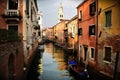 VENICE, ITALY - Feb 09, 2016: A typical Venetian canal, with Venetian architecture on both sides reflecting in the canal\'s water