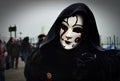 VENICE, ITALY - Feb 09, 2016: A Venetian masquerade in costume with a sad mask at the carnival of Venice