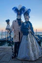 Couple in blue at the Carnival of Venice at dusk Royalty Free Stock Photo