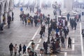 Venice Italy elevated day view of street vendor selling hats and carnival masks, with tourists on Saint Mark Royalty Free Stock Photo