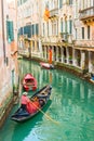 A gondola drifts down a narrow canal in Venice, Italy Royalty Free Stock Photo