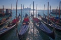 Traditional gondolas at quay in front of San Giorgio Maggiore island in the sun Royalty Free Stock Photo