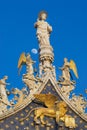 Statues of lion, angels and Jesus Christ decorating upper facade of the Saint Mark`s Basilica in Venice, Italy.