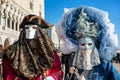 Couple of participants in costumes during carnival in Venice.