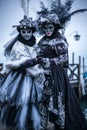 Women with colorful Venetian costume and mask