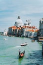 Venice, Italy. Gondola and tourist boats in Grand Canal. Basilica Santa Maria della Salute in background Royalty Free Stock Photo